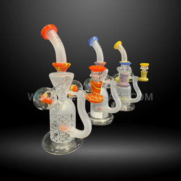 Set of colorful honeycomb frosted glass rigs with vibrant swirl accents in orange, blue, yellow, and multicolor. Wholesale smoking accessories.