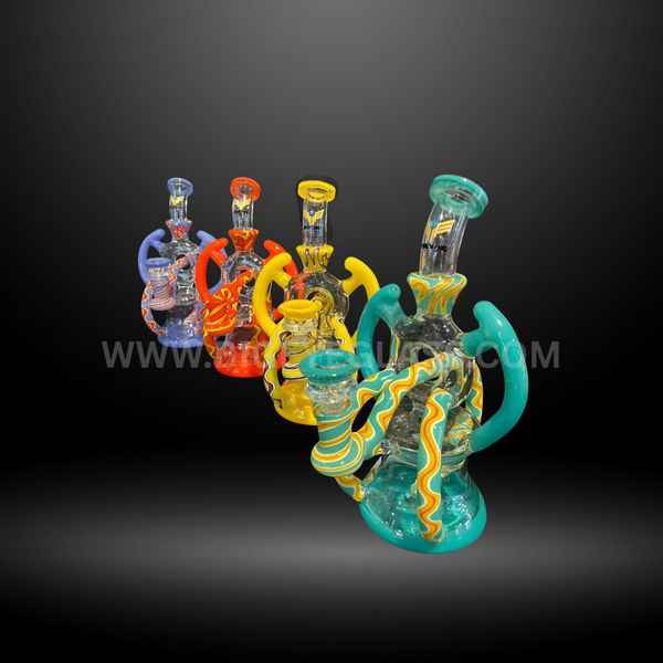 Set of four recycler-style glass water pipes in green, yellow, orange, and blue with vibrant swirl accents. Durable wholesale bongs for smoke shops.