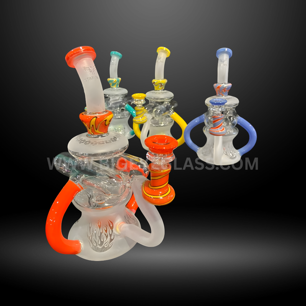 Set of colorful frosted glass recycler bongs with flame engravings and bold accent colors in red, yellow, blue, and green. Durable wholesale water pipes.