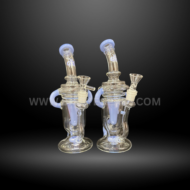 Set of two clear glass recycler bongs with light blue accents. High-quality wholesale water pipes for smooth smoking, ideal for head shops and distributors.