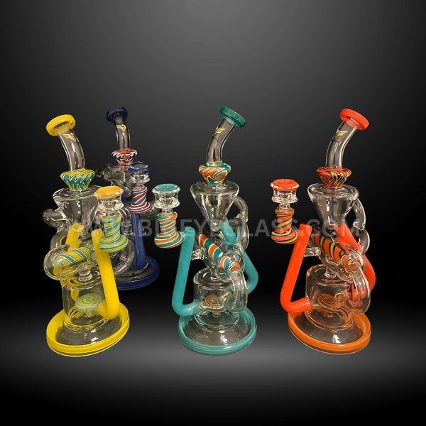 Set of four recycler-style glass water pipes with bold swirl handles in teal, yellow, blue, and orange. Premium wholesale bongs for smoke shops.