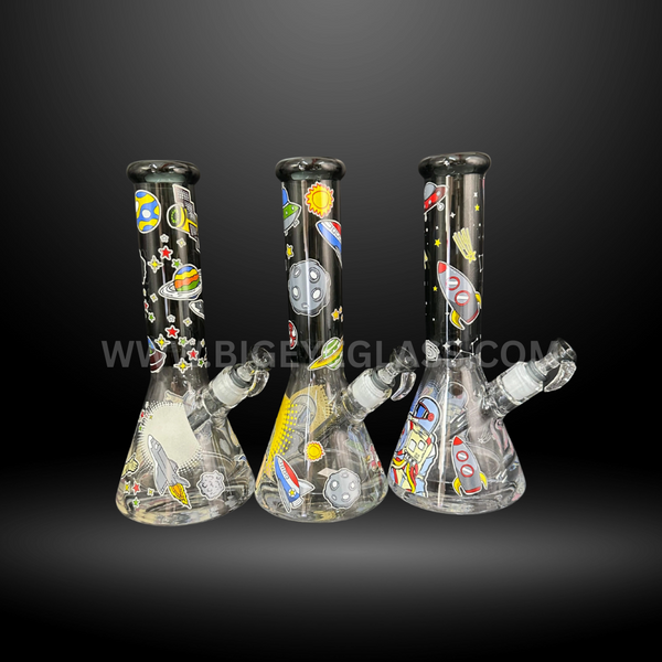 Set of three space-themed glass beaker bongs with rocket, UFO, and planet designs. Wholesale water pipes for smoke shops and distributors.