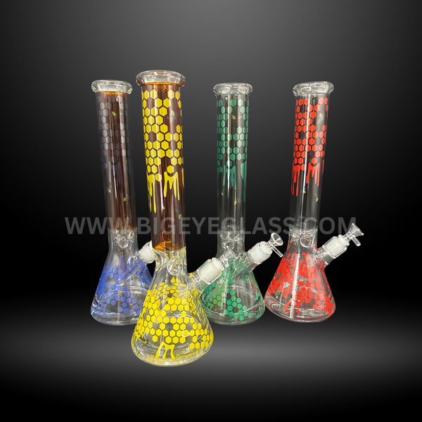 Set of four glass beaker bongs with vibrant honeycomb patterns in red, yellow, green, and blue. Durable wholesale water pipes for smoke shops and distributors.
