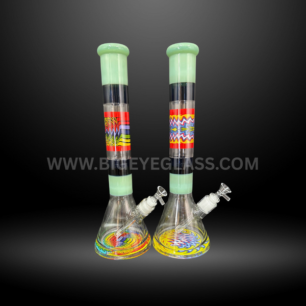 Two tall beaker glass bongs with colorful patterned designs and wide sturdy bases. Wholesale smoking accessories for head shops and distributors