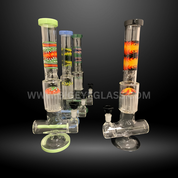 Set of tall colorful patterned glass perc bongs with intricate designs and percolators. Durable wholesale water pipes for smoke shops and distributors.