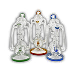 Clear glass recycler bong featuring multi-arm tubing, internal percolator system, circular chambers, and colored accent rings in green, amber, and blue.