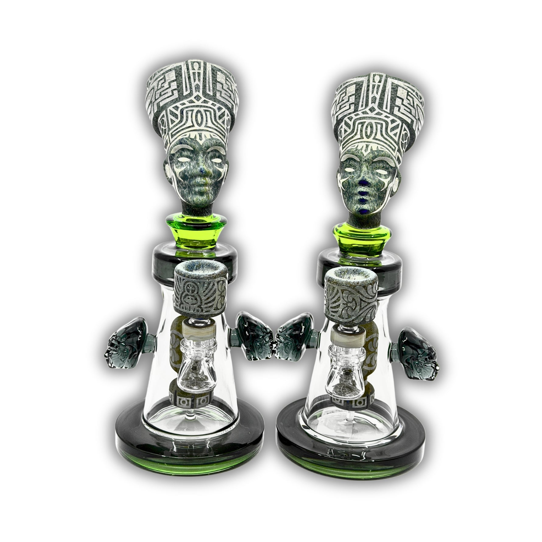 Artistic glass dab rig featuring an ancient queen head sculpture, engraved tribal details, and matching decorative bowl accents.