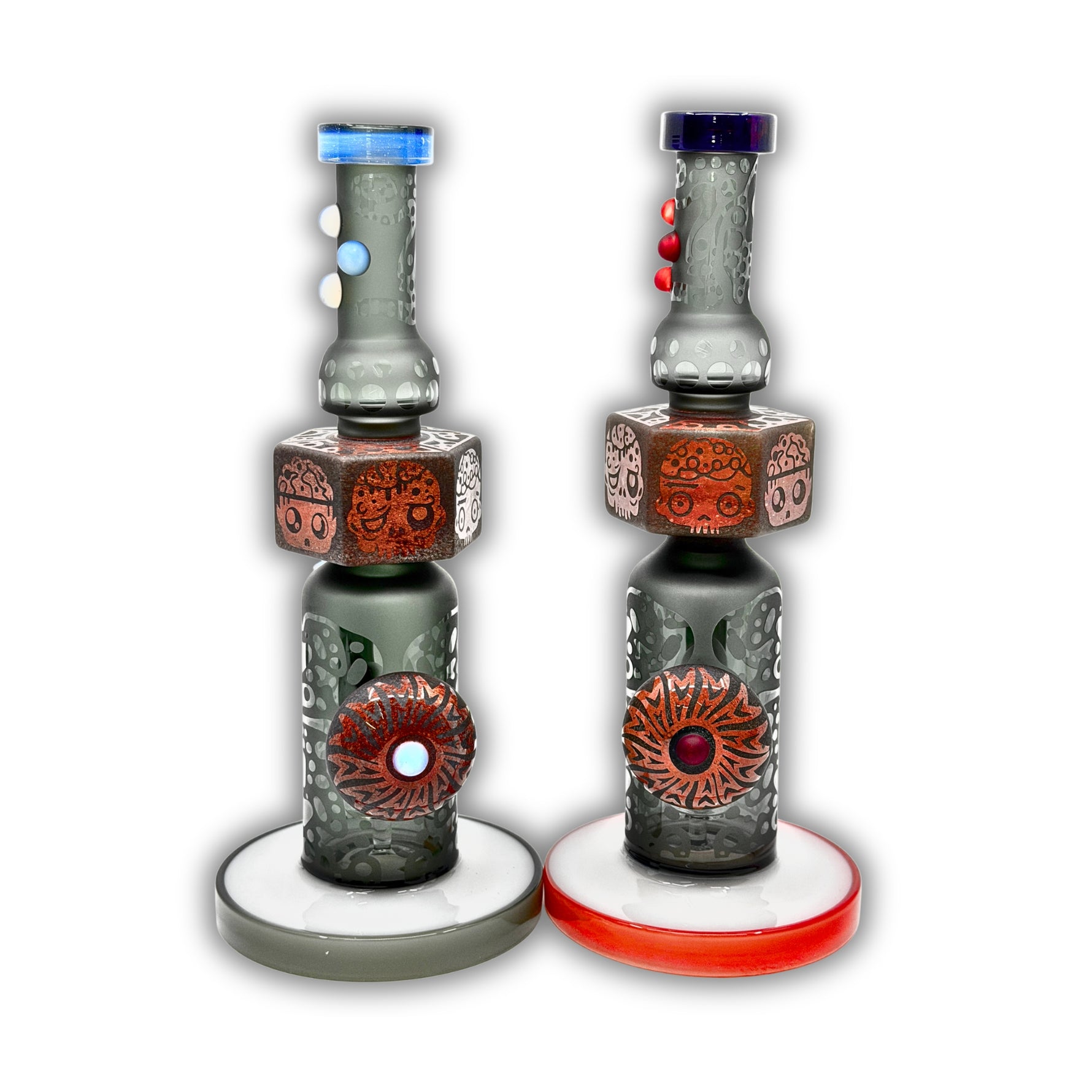 Decorative glass bong with sandblasted tribal artwork, stacked skull totem design, and colorful accent detailing on a straight tube body.