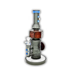 Decorative glass bong with sandblasted tribal artwork, stacked skull totem design, and colorful accent detailing on a straight tube body.