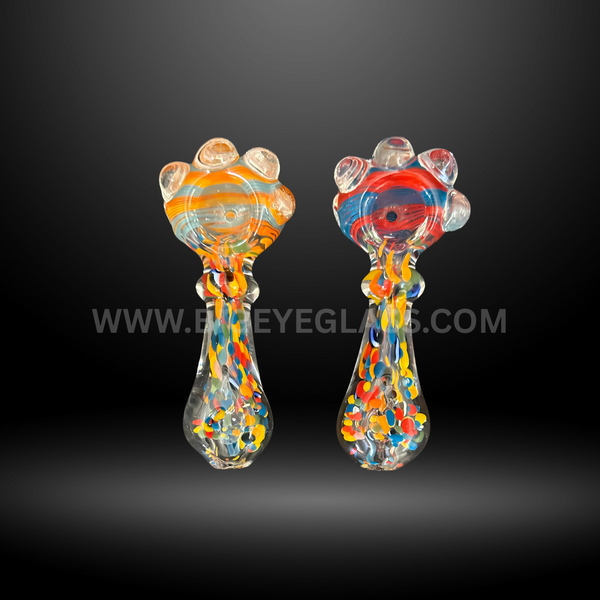 Assorted 4-inch frit glass hand pipes featuring colorful spotted bodies, knobbed bowls, and artistic swirl designs. Wholesale pipes for smoke shops and head shops.
