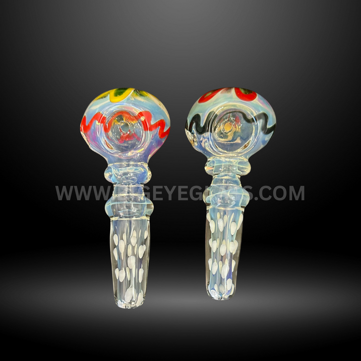 Two clear glass hand pipes with colorful rasta-inspired bowl designs and dotted handles, durable wholesale smoking accessories for smoke shops