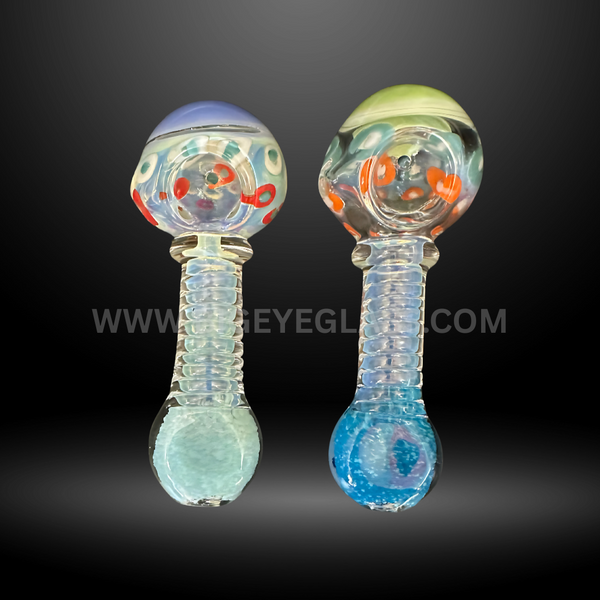 Assorted 5-inch glass hand pipes with colorful dot designs, ribbed handles, and rounded bottoms. Wholesale smoking pipes for smoke shops and head shops.