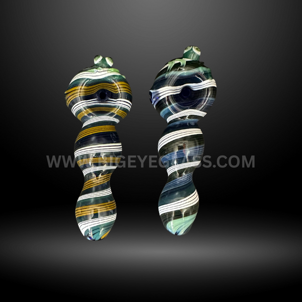 Two dark-colored glass hand pipes with white, gold, and green stripe patterns, unique wholesale smoking pipes for smoke shops.