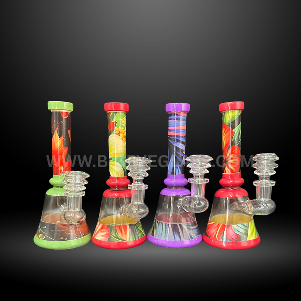 Set of four floral patterned glass beaker bongs with vibrant red, green, and purple accents. Durable wholesale water pipes for head shops and distributors.