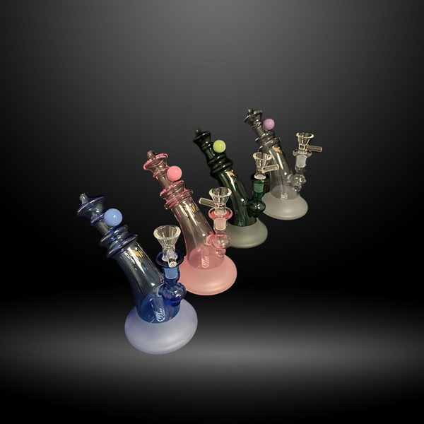 6" Wholesale Small Recycler Water Pipe is a  collection of colorful glass water pipes with a clear round handle bowl, displayed against a neutral background. In colors blue, pink, green, and black.