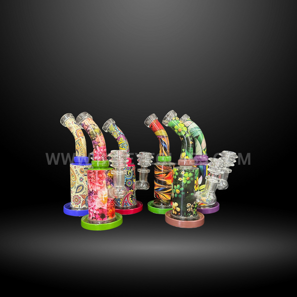 Collection of colorful patterned glass dab rigs with floral, paisley, and abstract designs. High-quality wholesale water pipes for smoke shops and distributors.
