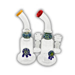 Compact glass dab rig featuring a bubble chamber with decorative turtle accent and spotted glass marble detail, available with colored mouthpieces.