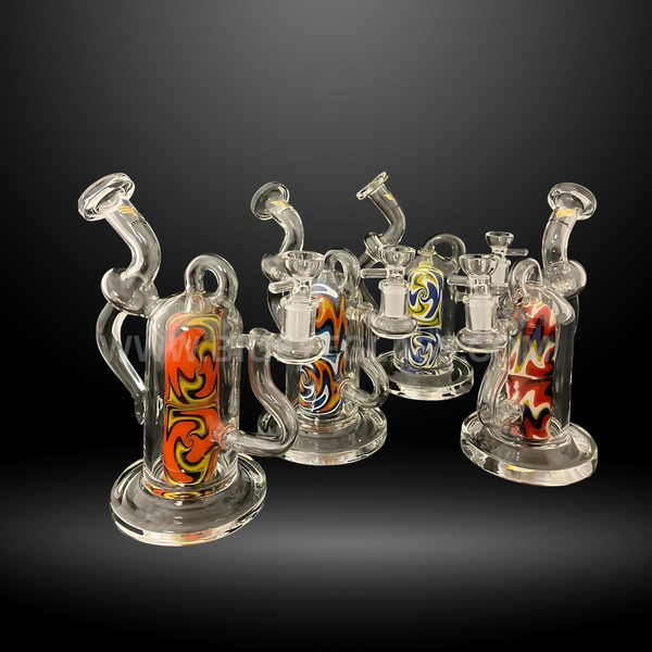 Set of recycler glass rigs with colorful inline swirl designs in red, yellow, blue, and black. Durable wholesale dab rigs for smoke shops and distributors.