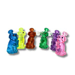 Colorful glass dab rigs shaped like cartoon dogs in blue, yellow, orange, green, purple, and pink with built-in bowl and downstem.