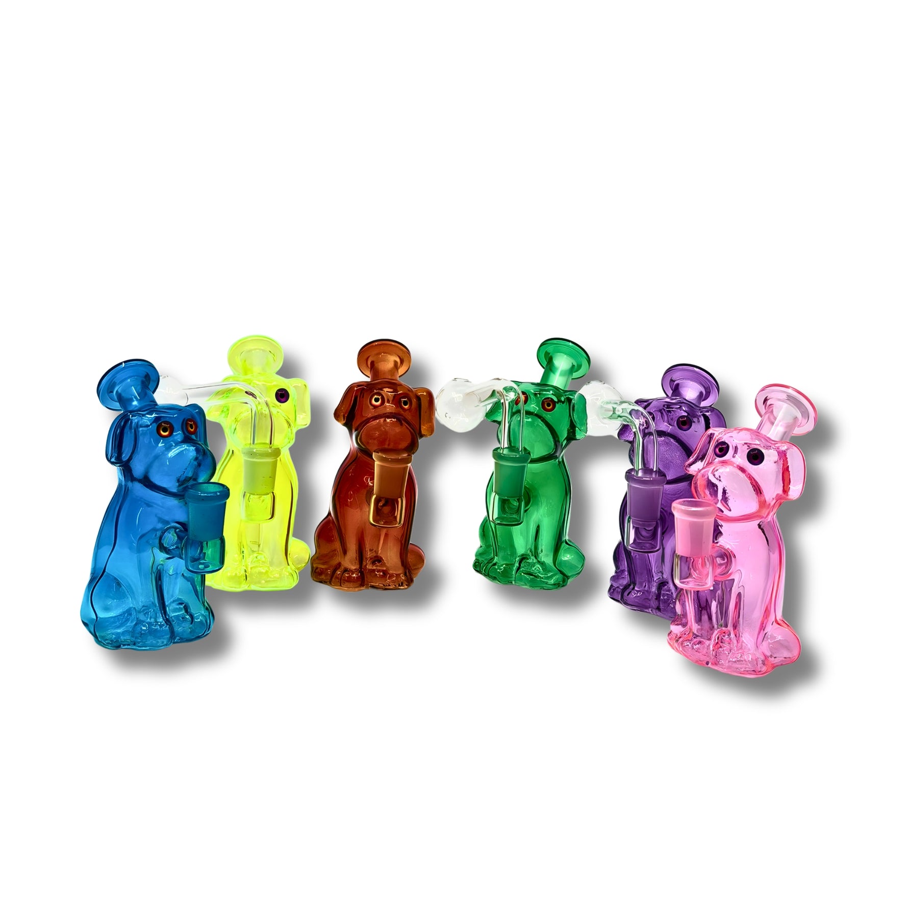Colorful glass dab rigs shaped like cartoon dogs in blue, yellow, orange, green, purple, and pink with built-in bowl and downstem.