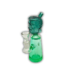 Glass water pipe featuring a sculpted face head design with a colored base and compact body.