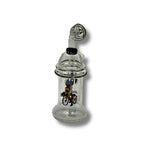 Clear glass dab rigs with printed cartoon graphics and spinner caps in assorted colors, featuring compact chamber design.