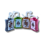 Glass oil burner  designed like playing cards with spade symbols in black, green, amber, and pink colors.