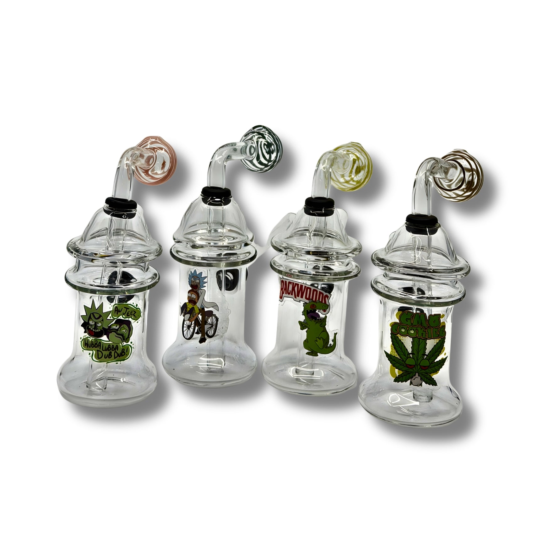 Clear glass dab rigs with printed cartoon graphics and spinner caps in assorted colors, featuring compact chamber design.