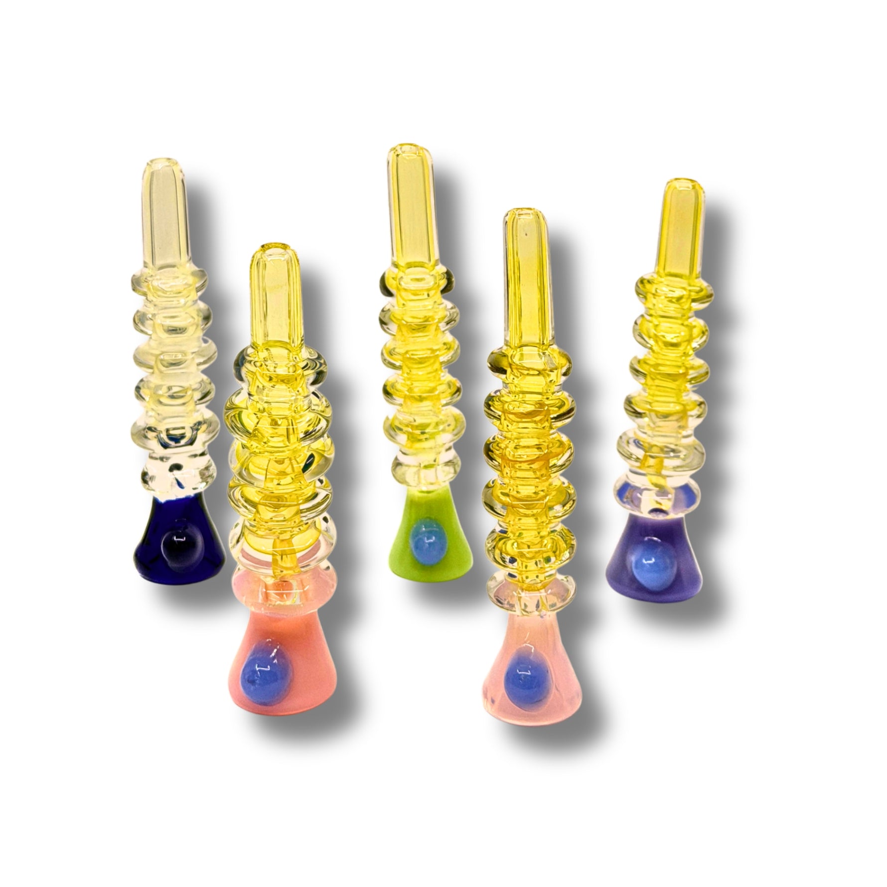 Transparent yellow glass chillum pipes with stacked ring texture and colorful base accents.