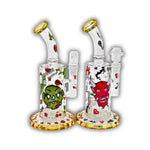 Mini glass bong with colorful zombie and devil graphics, gold-accented rim and base, and compact filtration chamber.
